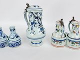 four different types of vases sitting on a white surface