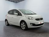 the small white car is parked in a large room