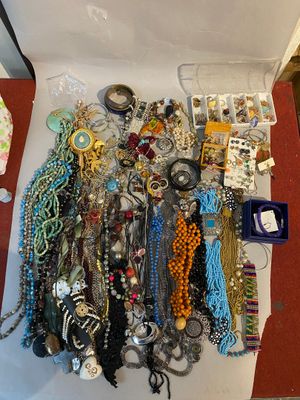 a white box filled with lots of jewelry on the floor