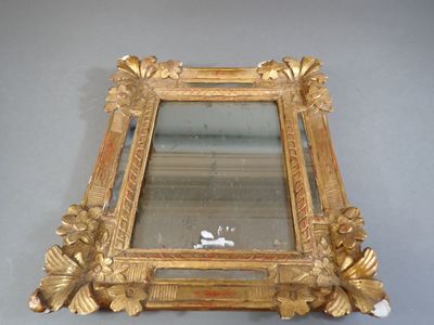 Miroir à parecloses en bois doré et stuqué à décor en relief…