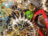 a pile of assorted jewelry sitting on a table