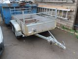 a trailer that is parked in front of a building