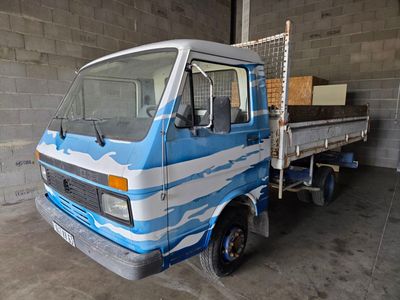 a blue and white truck parked inside of a building