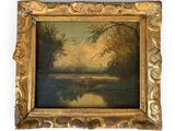 a painting of a river in a golden frame on a white wall