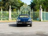a blue car that is parked in front of a gate