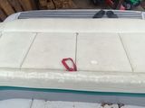 a pair of red scissors sitting on top of a boat