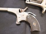 two revolvers that are laying on a black cloth