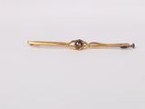 an antique gold tie bar with a knot on it