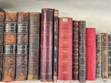 many old books on a shelf in a room