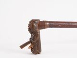 an old wooden stick with a man holding a stick