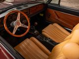a brown leather seat and steering wheel in a car