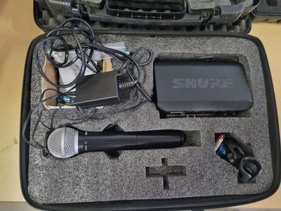 a case that has a microphone, a microphone, and other items in it