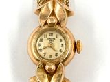 an image of a close up of a wrist watch on a white surface
