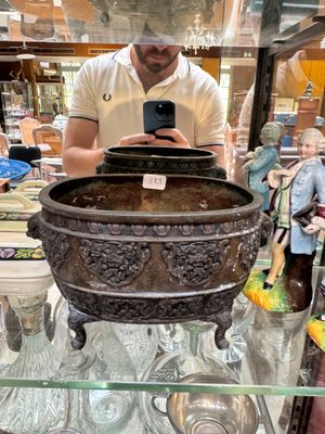 a man that is taking a picture of a bowl