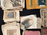 a lot of old papers and old photos on a table