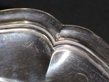 a close up of a silver plate on a table
