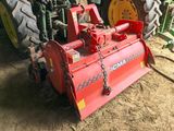 a tractor with a plow attached to it in the dirt