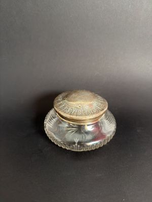 an image of a small glass jar with a lid on a table