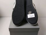 the black and white shoes are sitting on top of a box