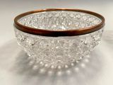 a glass bowl with a wooden rim sitting on a table
