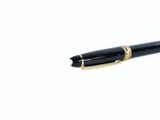 a pen that is laying on top of a white surface