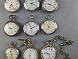 many different types of pocket watches on the table