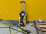 a power washer and a hose on the floor