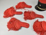 five pairs of red gloves and a hat on a table