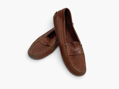 a pair of brown loafers on a white background