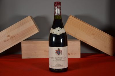 a bottle of wine sitting on a table next to two wooden boxes