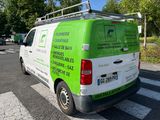 a green and white van parked on the side of the road