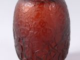 a red glass vase with a pattern on it