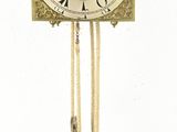 a clock with a pendulum hanging from the side of it
