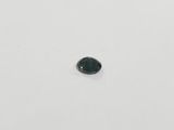 a green tourmaline gemstone on a white surface