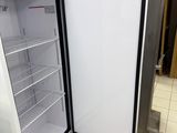 a refrigerator that is open on the floor in the kitchen