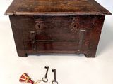 a small wooden chest with two keys and a keychain