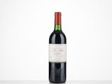 a bottle of red wine sitting on top of a table