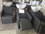 three chairs and a sink in a salon room