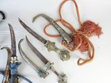 many different types of knives on a white surface