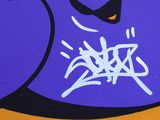 graffiti on a wall of a purple and yellow building with a black face
