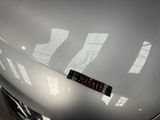 a sticker on the hood of a silver car