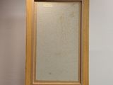 an empty wooden easel with a painting on top of it