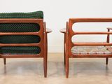 pair of mid century danish teak lounge chairs with green upholstered cushions