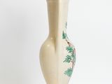 a white vase with a pine tree design on it