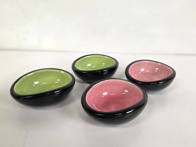 Trois petits bols sont posés sur une table sur fond blanc