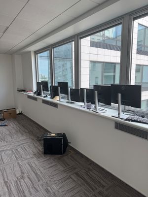 a room with a lot of computers on the windows
