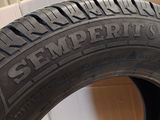 a close up of a tire on a cardboard box with a box in the background