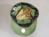 a green hat with a black band on it