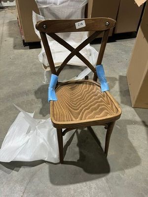 a wooden chair that has been painted with blue tape