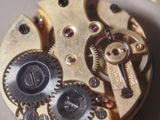a close up view of a watch mechanism with gears
